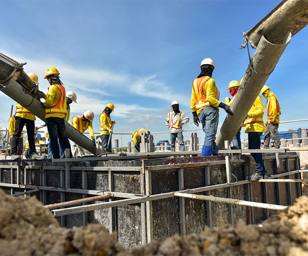 Construction workers pouring concrete